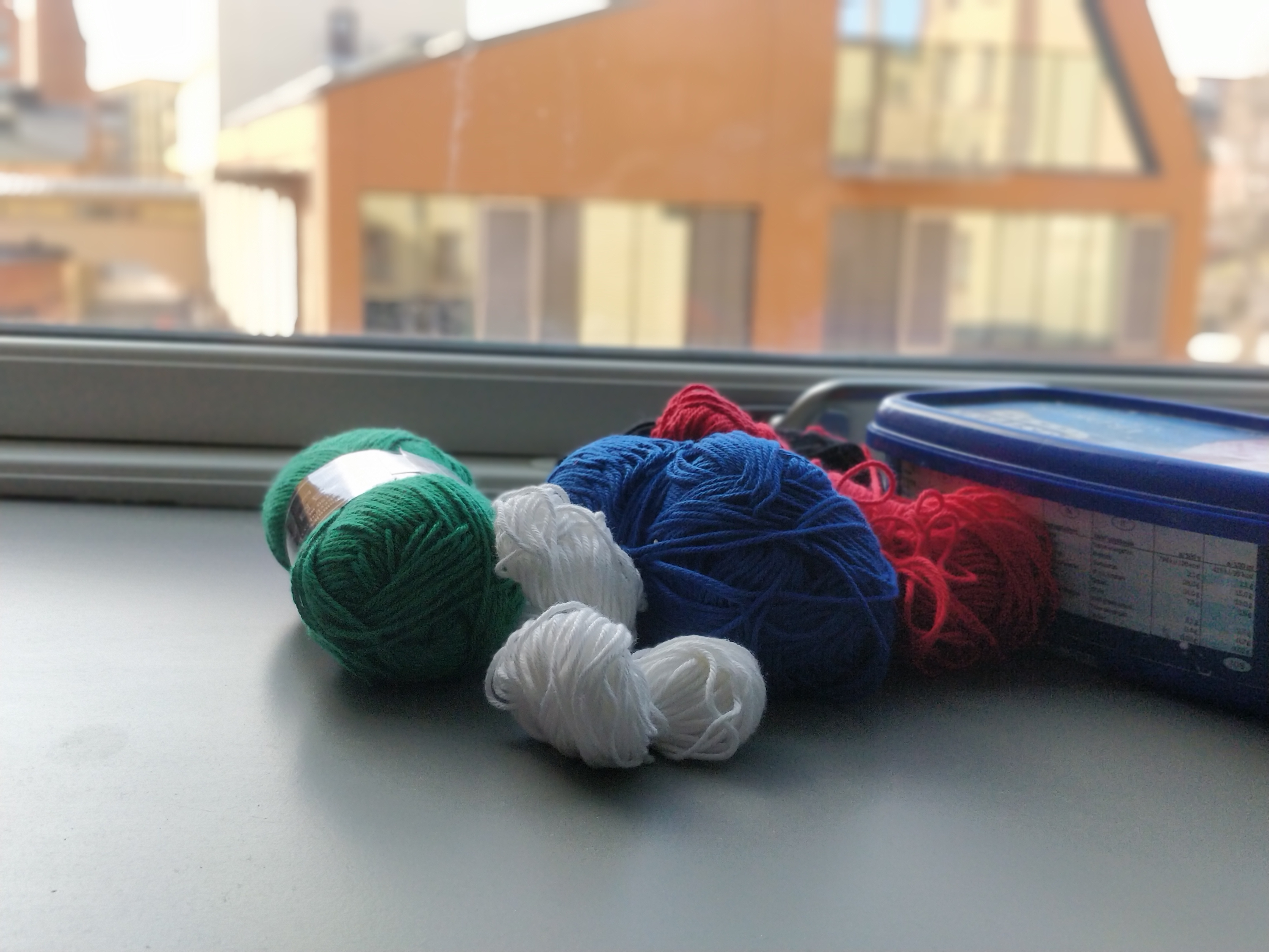Yarn balls by a window.
